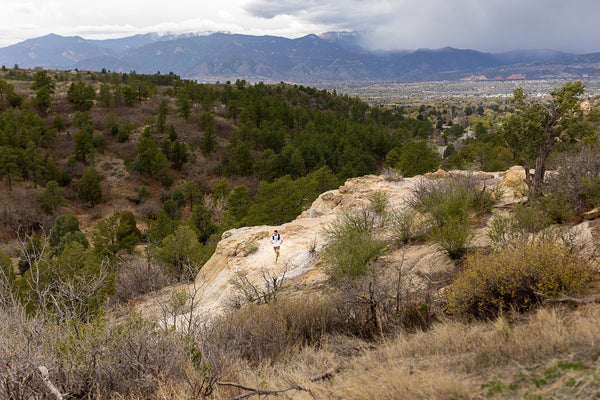 wide shot of man running on a trail