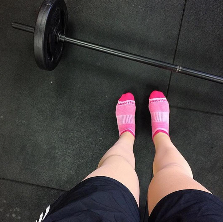 Barbell next to feet that are wearing the best socks for sensitive feet