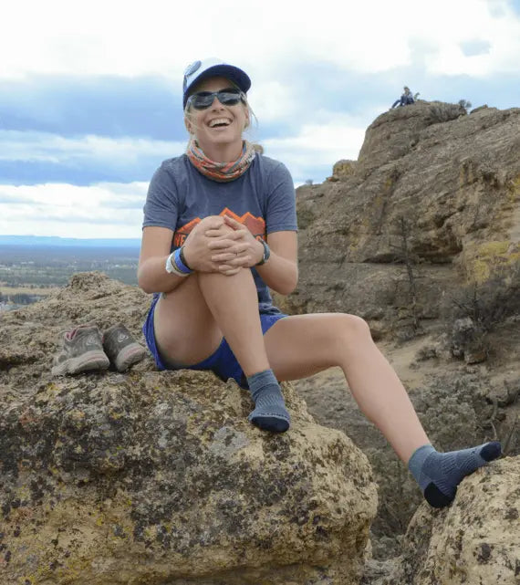 A woman wearing wrightsocks on a mountain