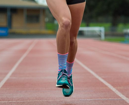 A femalte track runner wearing track socks