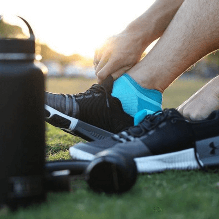 man putting on marathon socks