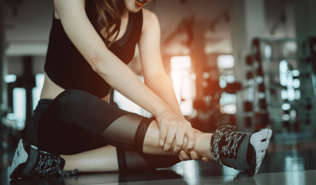 Woman with blisters wearing running shoes
