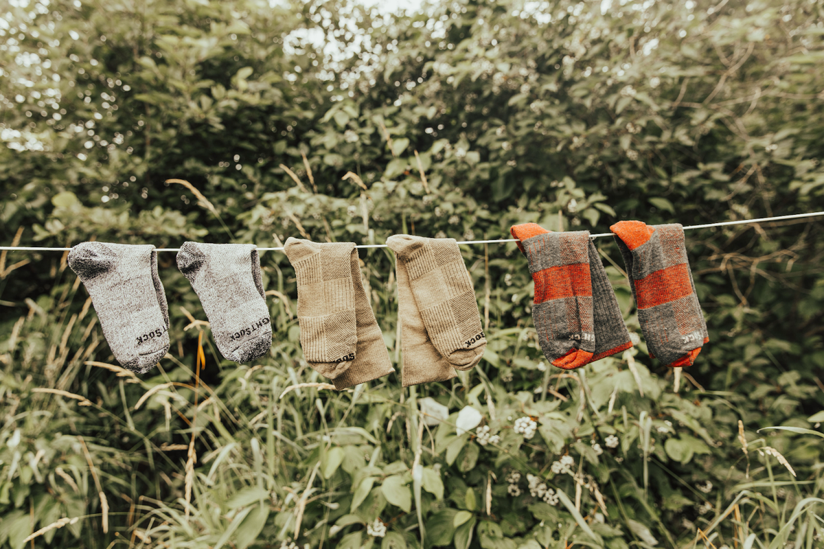 Three pairs of socks hanging from clothesline