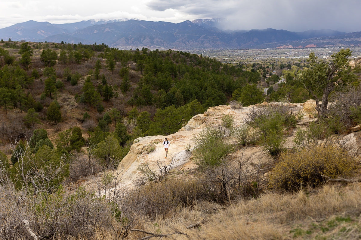 wide shot of man running on a trail