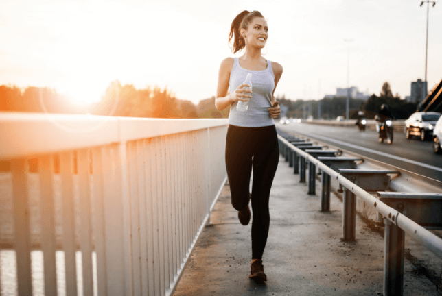Woman running at sunrise