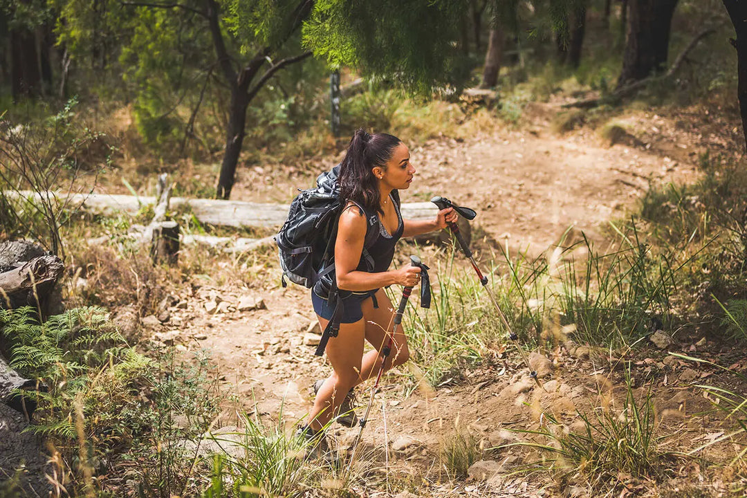 A person treking on a path and wearing Double Layer Trail Socks.