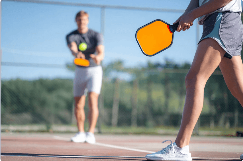 A pair of people playing pickleball and wearing Wrightsock Double Layer Pickleball Socks.