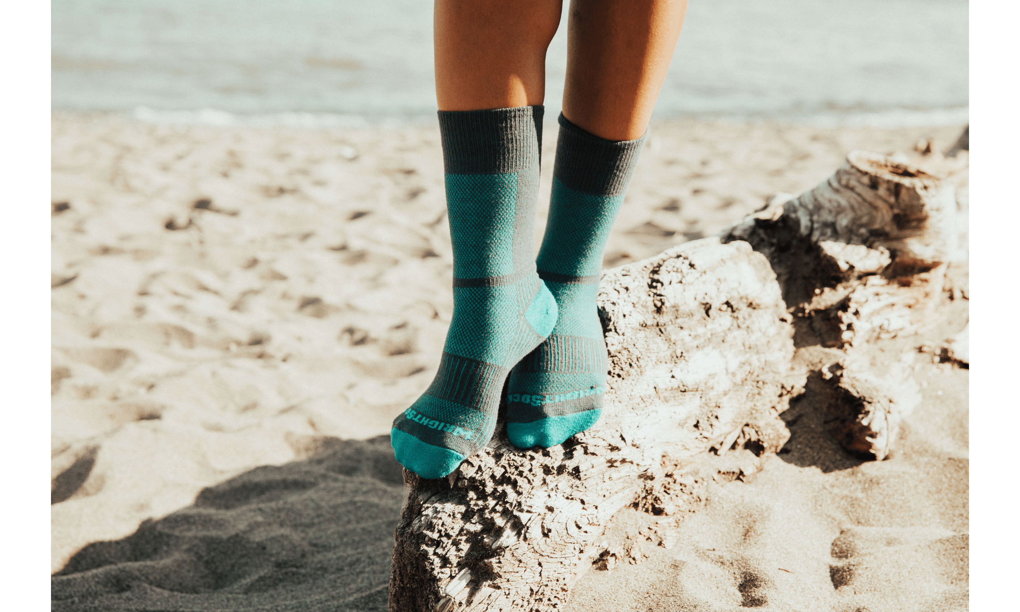 woman wearing blister free socks on a beach
