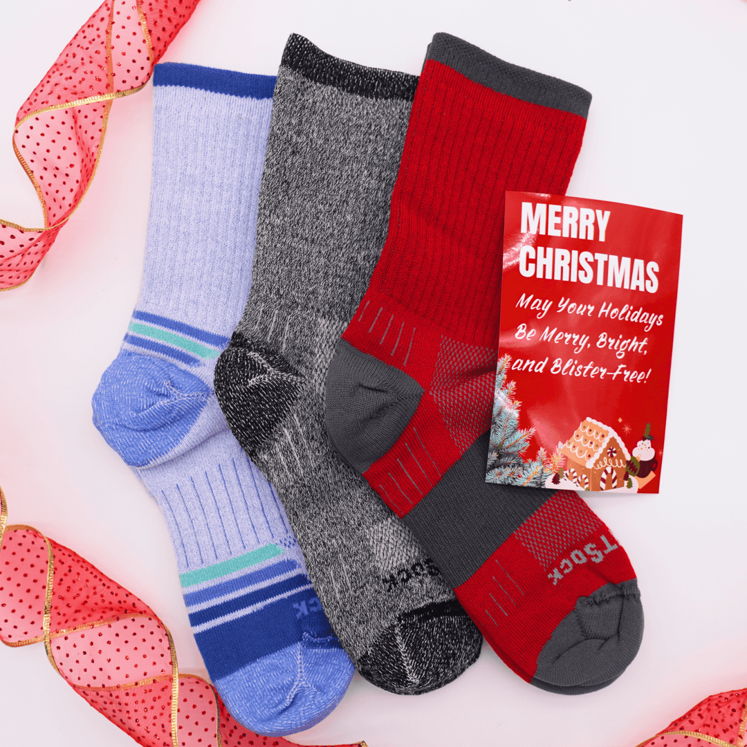 Three pairs of Escape Crew socks in blue, gray, and red with a Christmas card on a white background.
