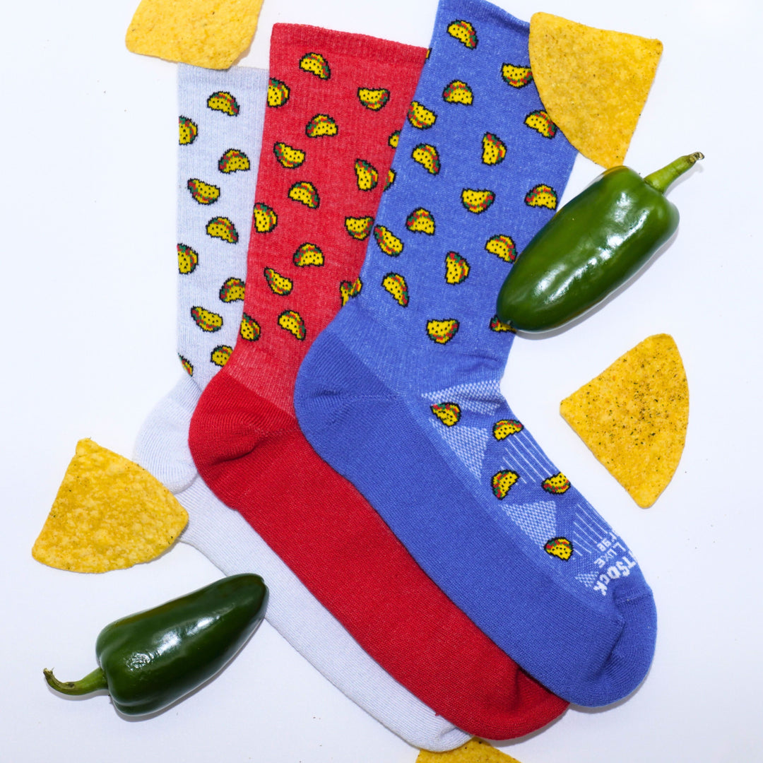Run Luxe taco socks layed out with chips and jalapenos. 
